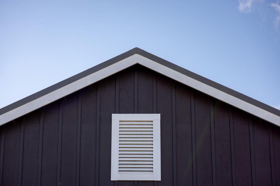 Free Image of Architectural details of a rustic house against a clear sky 
