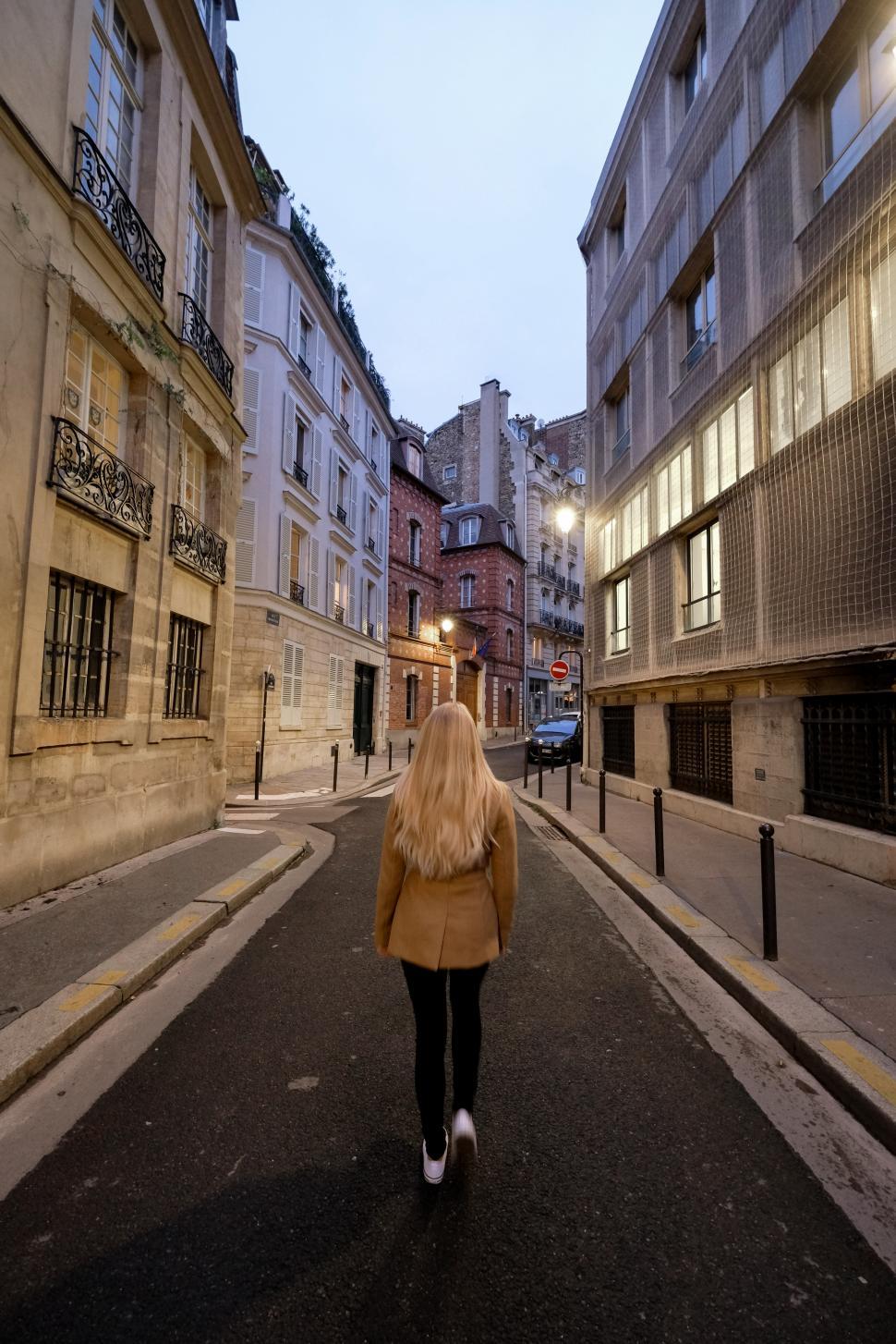 Free Image of Strolling a quiet Paris street at dusk with historic charm and soft lights 
