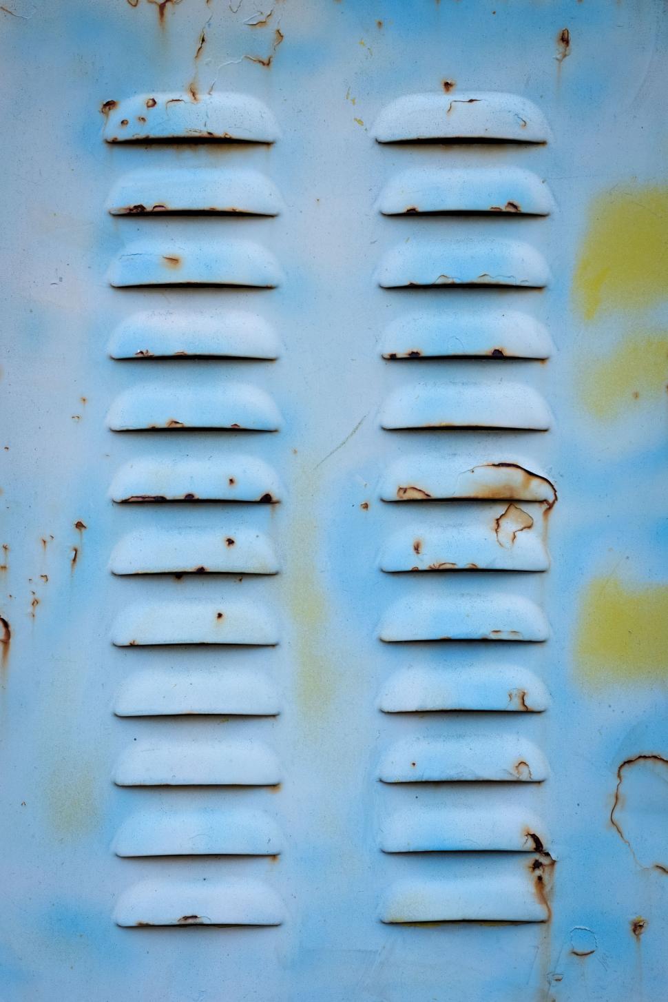 Free Image of Weathered blue metal surface with ventilation slats and rust spots 