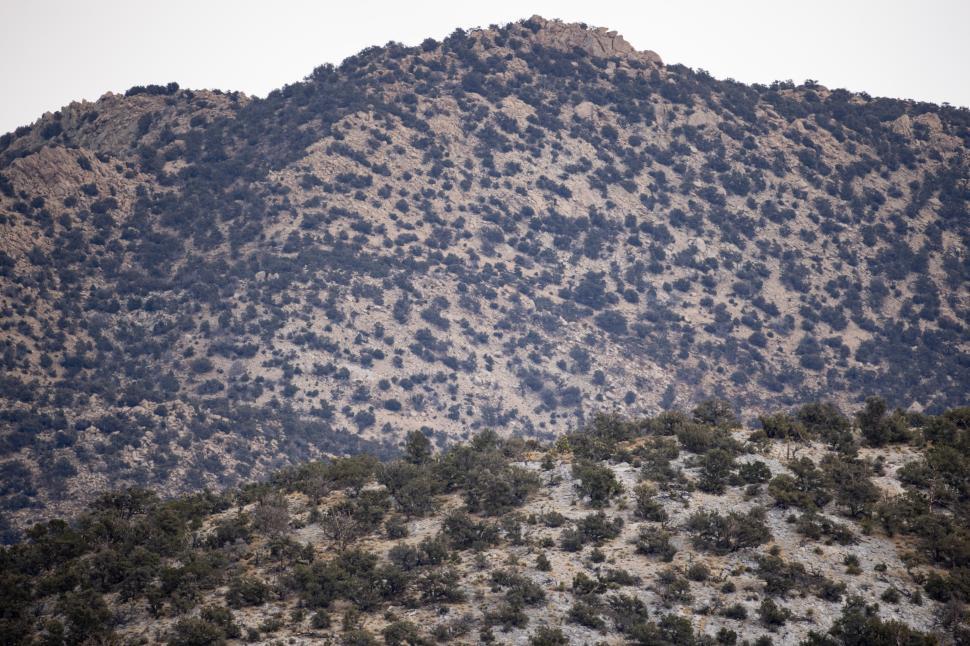 Free Image of View of rugged mountains under a cloudy sky in mid-afternoon light 