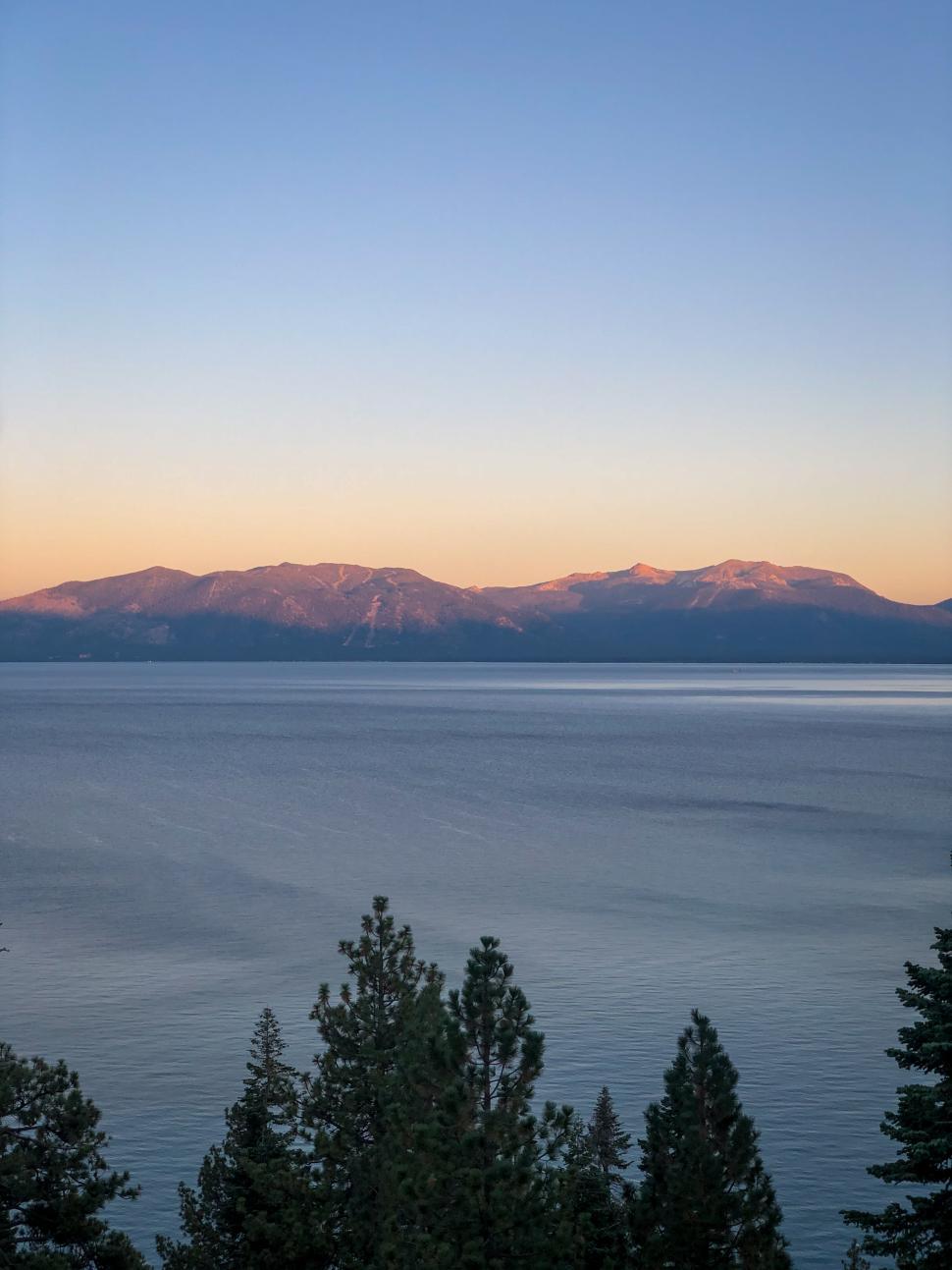 Free Image of Sunset view over Lake Tahoe with mountains in the background 