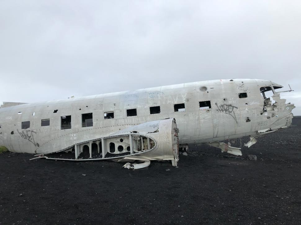 Free Image of Wreckage of vintage aircraft on a black sand beach in Iceland 