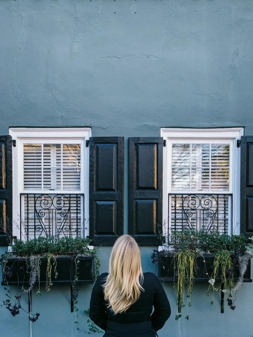 Free Image of Woman admires charming architecture of historic building in the city 