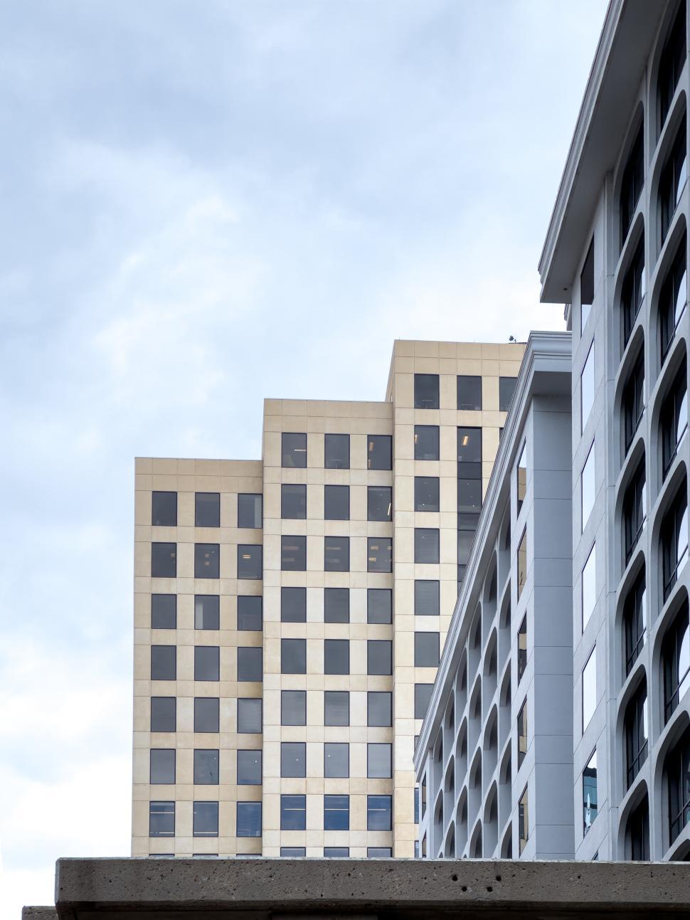 Free Image of Modern office buildings under cloudy sky in urban setting downtown 