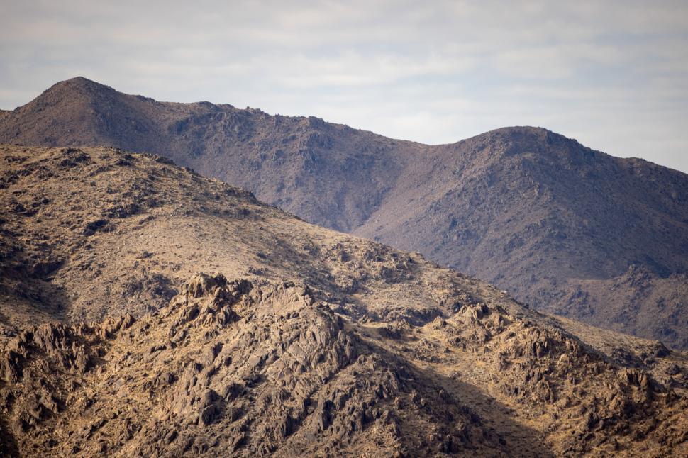 Free Image of Mountain landscape with rocky terrain and gentle slopes in daylight 