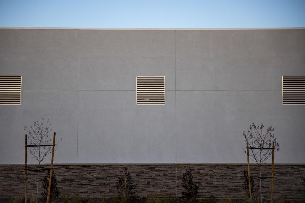 Free Image of Modern industrial wall with ventilation and minimalist landscaping 