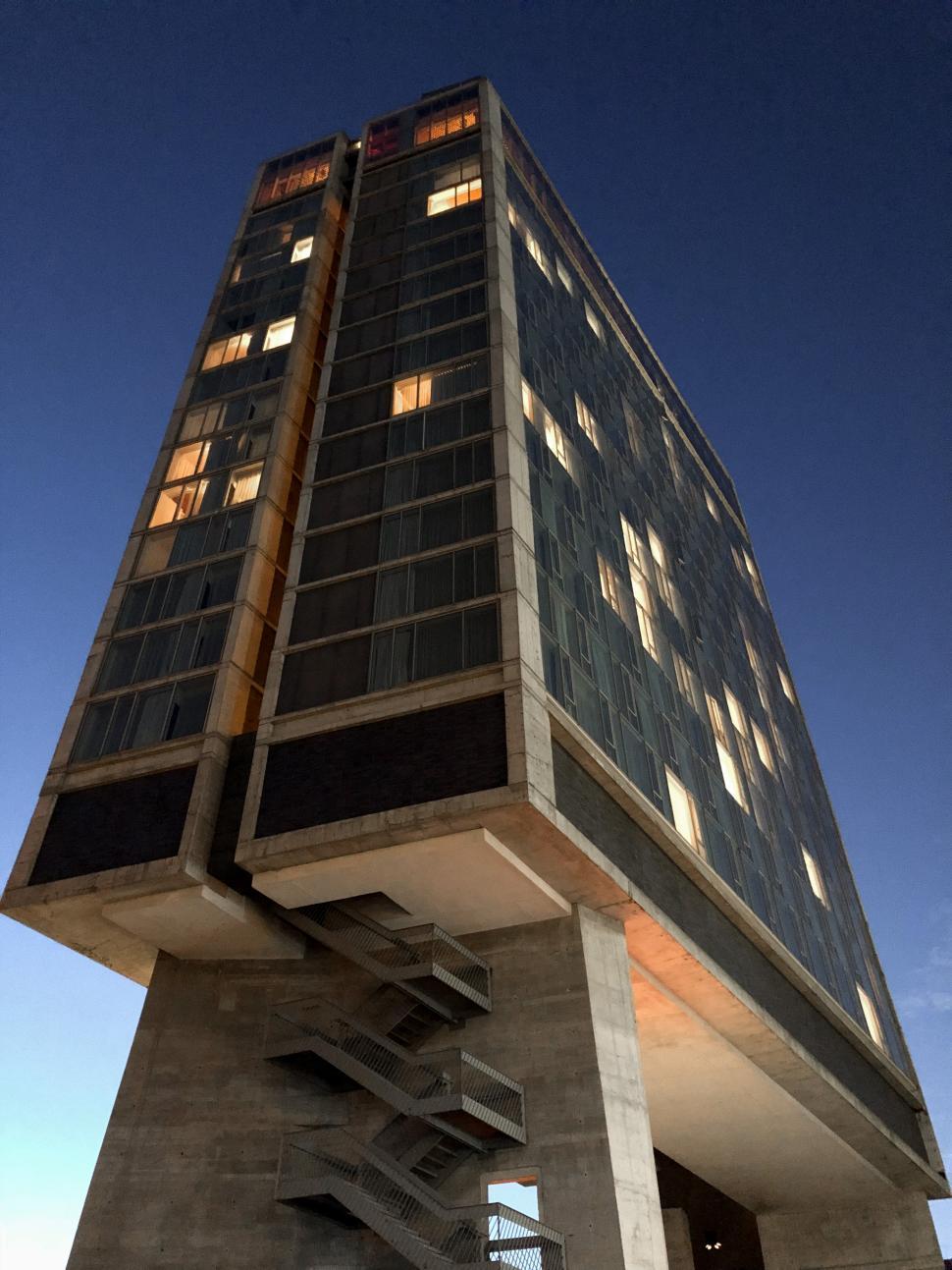 Free Image of Modern architectural marvel stands tall against the evening sky 