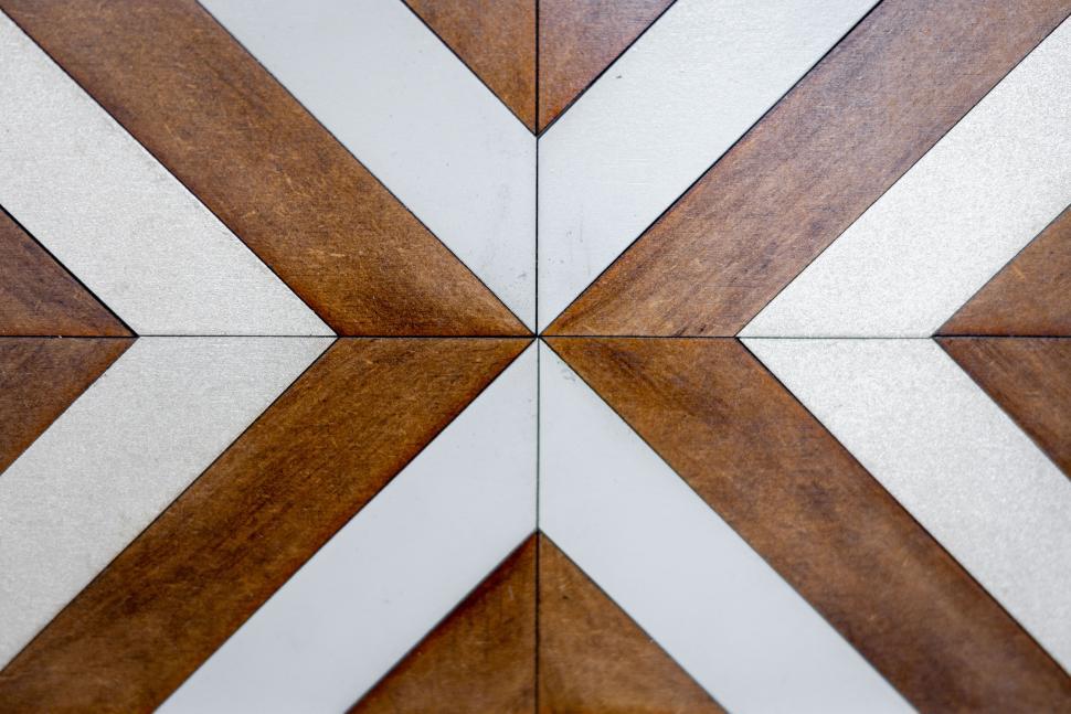 Free Image of Detailed wooden and white geometric tile pattern on the floor 