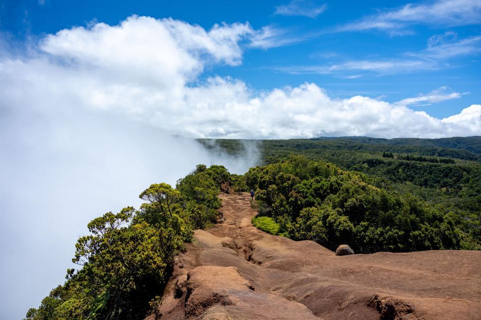 Free Image of Stunning landscape view from a rocky cliff overlooking lush forests 