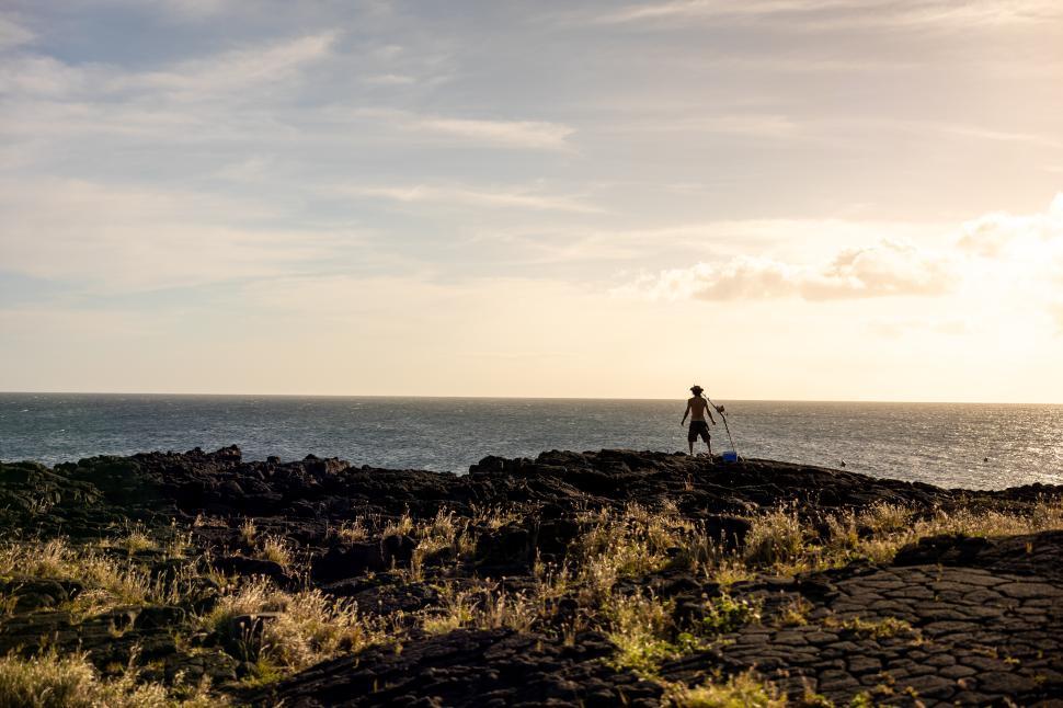 Free Image of Exploring rocky coastline at sunset near the ocean 