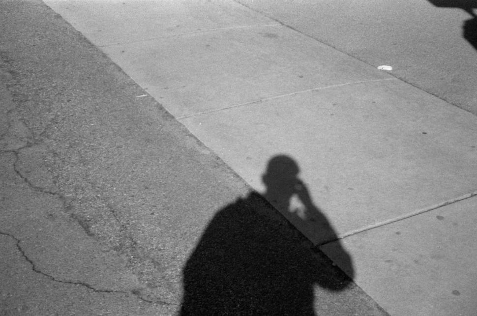 Free Image of Shadow of a person on a sidewalk during daylight hours 