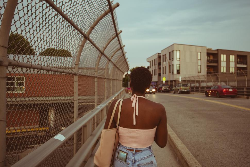 Free Image of Walking down a city street near modern buildings at dusk 