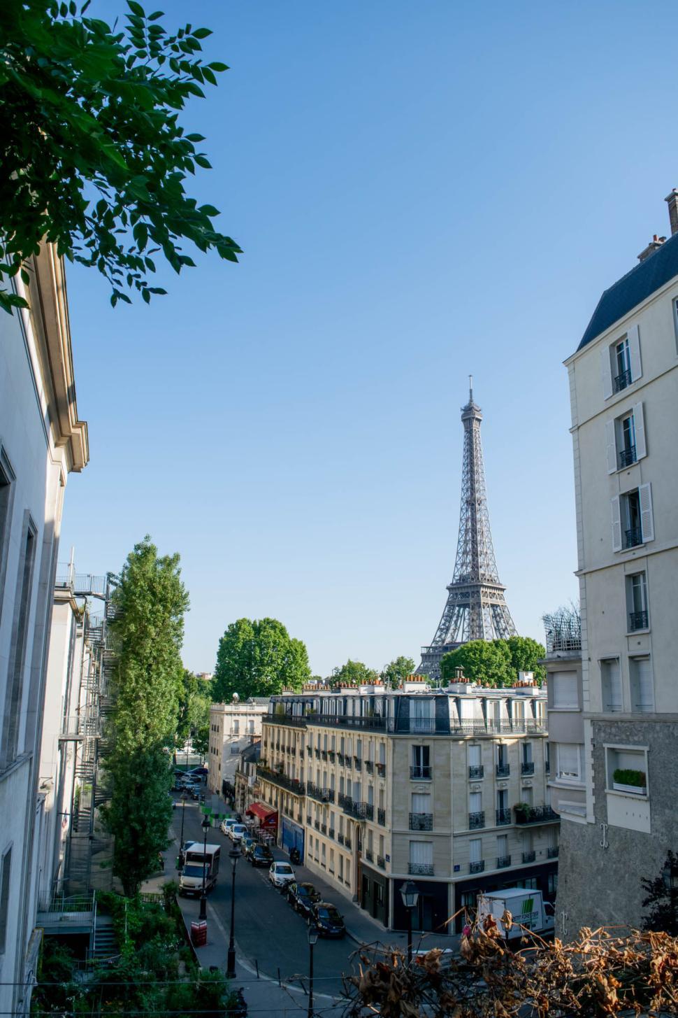Free Image of Eiffel Tower skyline view in peaceful Paris neighborhood 