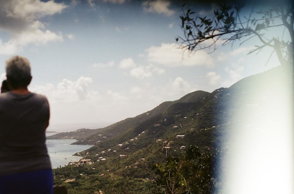 Free Image of Scenic view of coastal landscape with a person taking photos during daytime 
