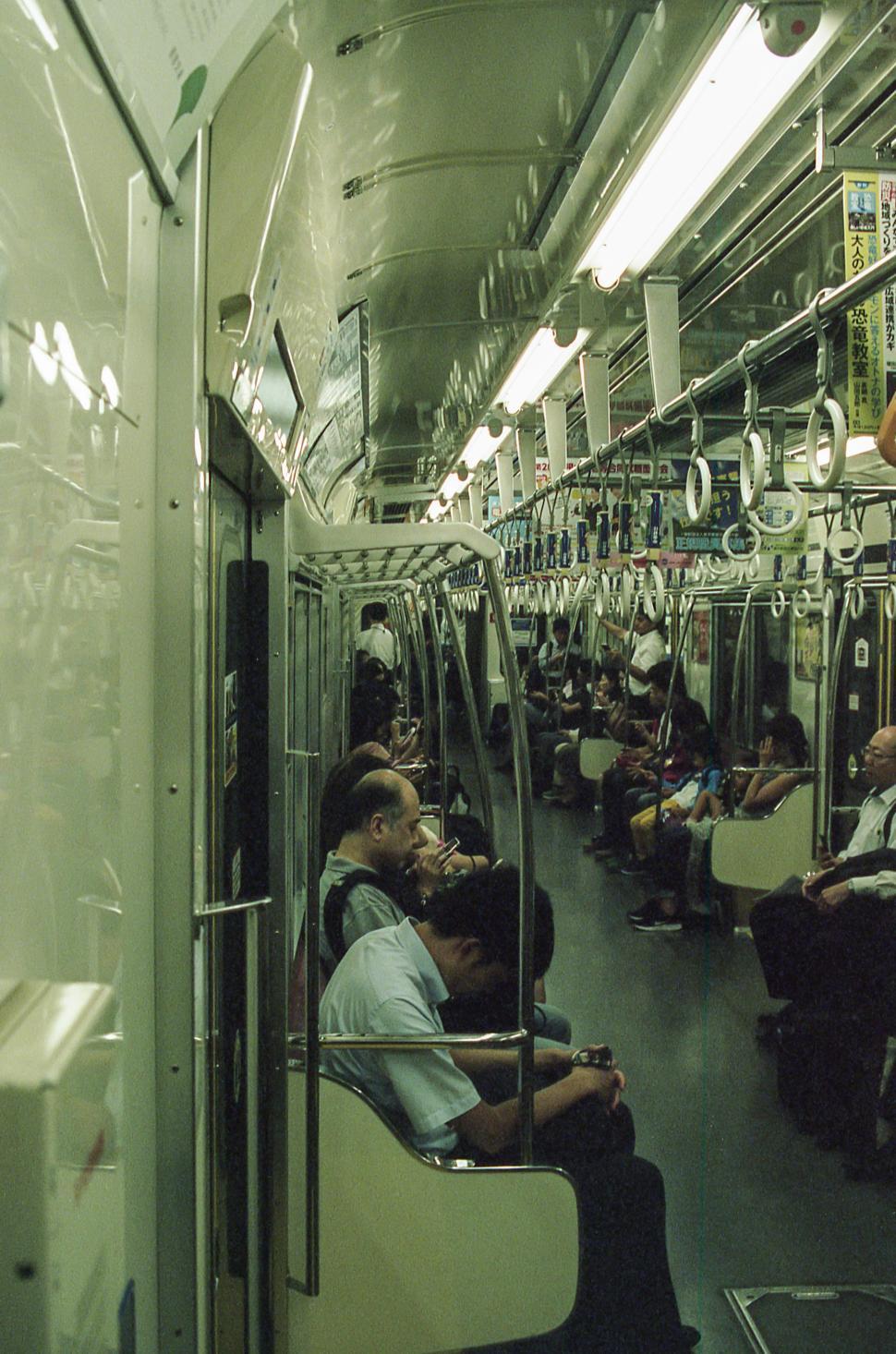 Free Image of Commuters on a busy subway train in a bustling city during the morning rush 