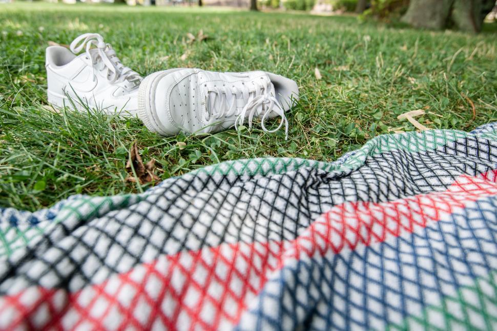 Free Image of Relaxing afternoon on the grass with a picnic blanket 