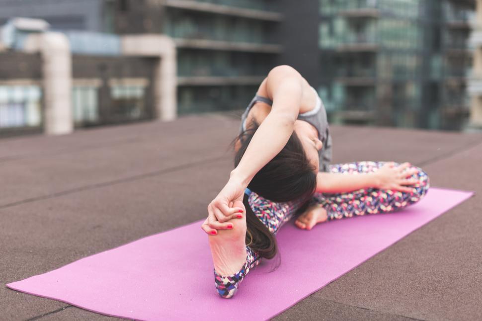 Free Image of Practicing yoga on a rooftop at sunset 