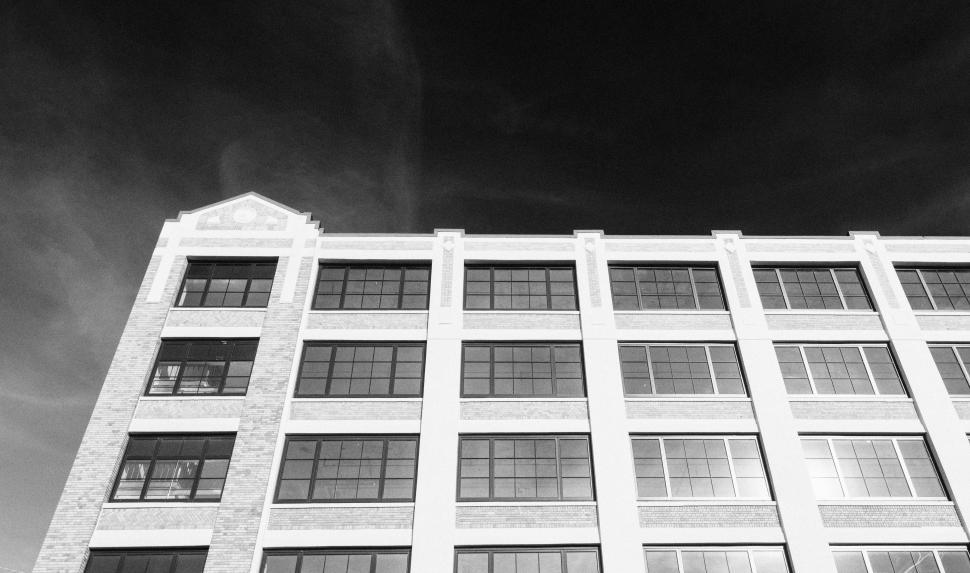 Free Image of Urban building with modern architecture under cloudy sky 