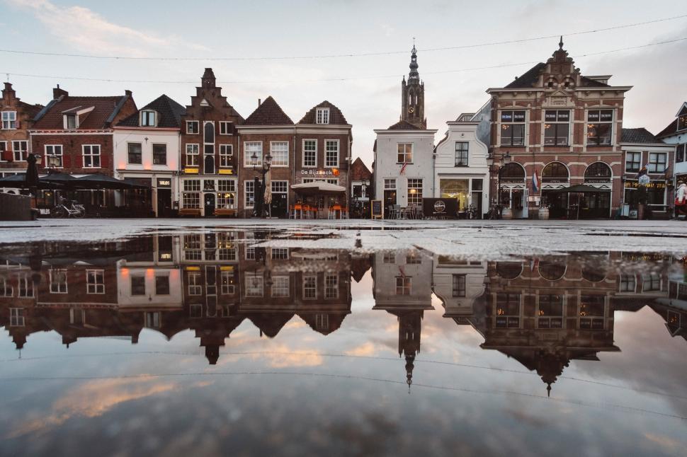 Free Image of Reflection of historic buildings in a Dutch town square 