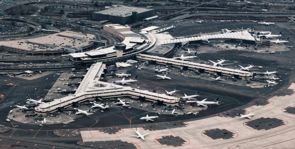 Free Image of Busy airport terminal with numerous airplanes on the runway 
