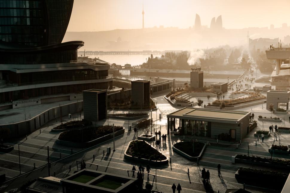 Free Image of Urban cityscape of Baku, Azerbaijan, under a stunning evening sunset, featuring the modern skyline bathed in warm golden light and a vibrant metropolitan atmosphere.  