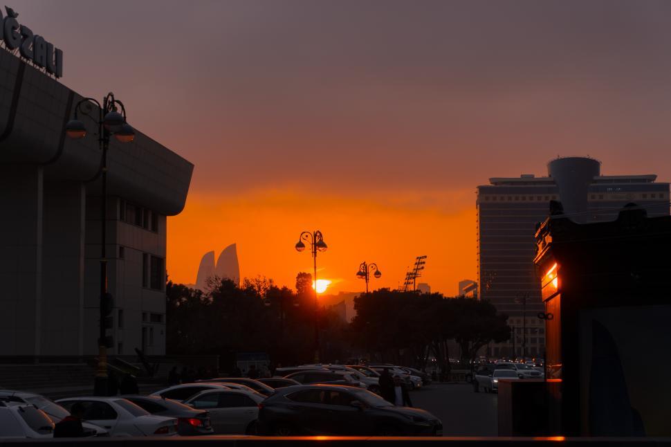 Free Image of Urban cityscape of Baku, Azerbaijan, under a stunning evening sunset, featuring the modern skyline bathed in warm golden light and a vibrant metropolitan atmosphere.  