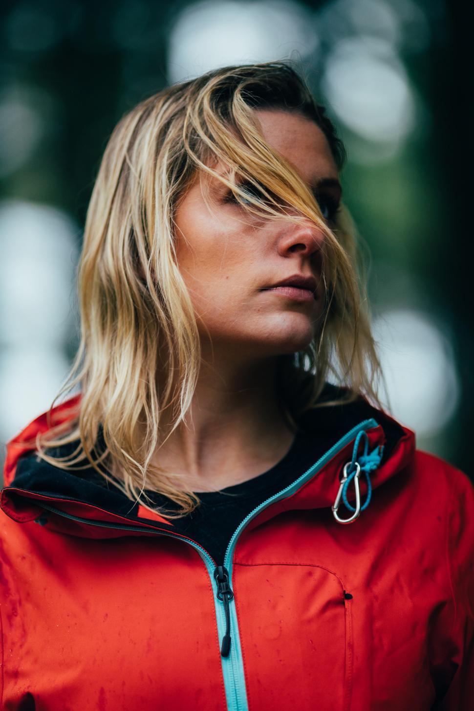 Free Image of Portrait of woman in red jacket outdoors in forest 