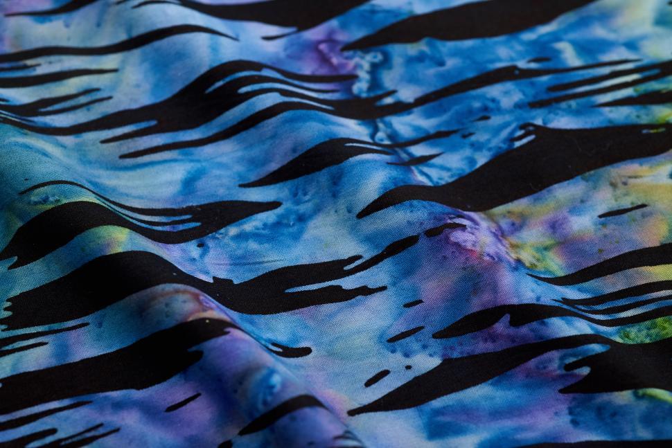 Free Image of Colorful fabric pattern with waves and abstract design in blue tones 