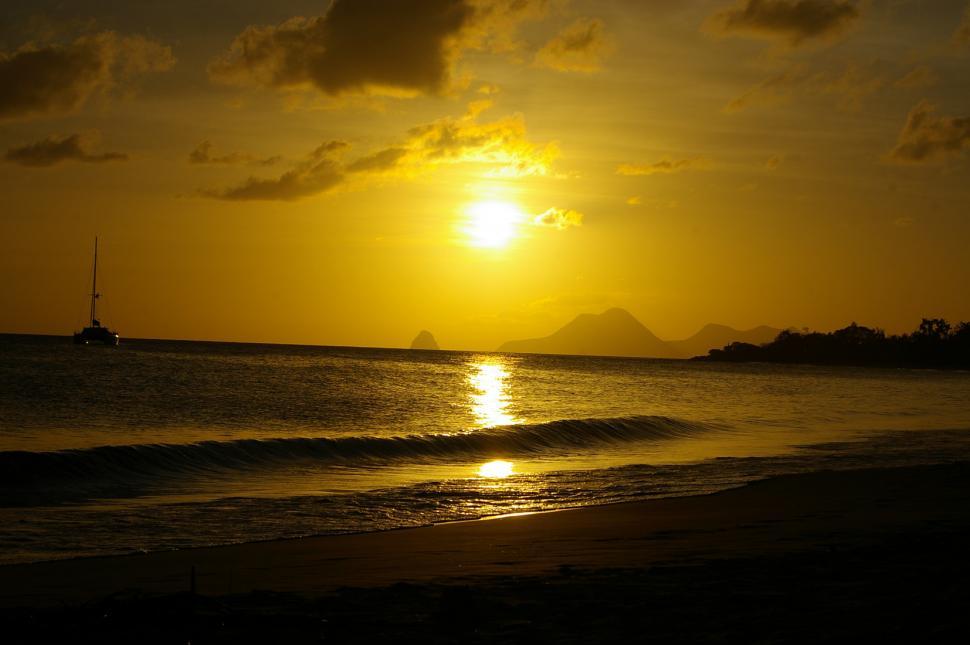 Free Stock Photo of Sun Setting Over Ocean With Boat in Distance ...