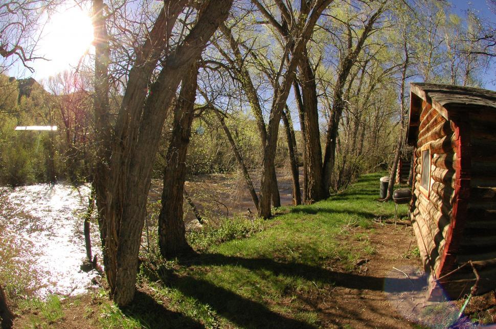 Free Image of Sunset by the River Cabin 