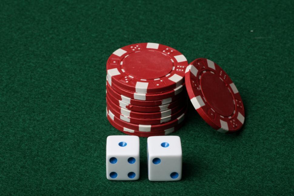 Two dice on red poker chips