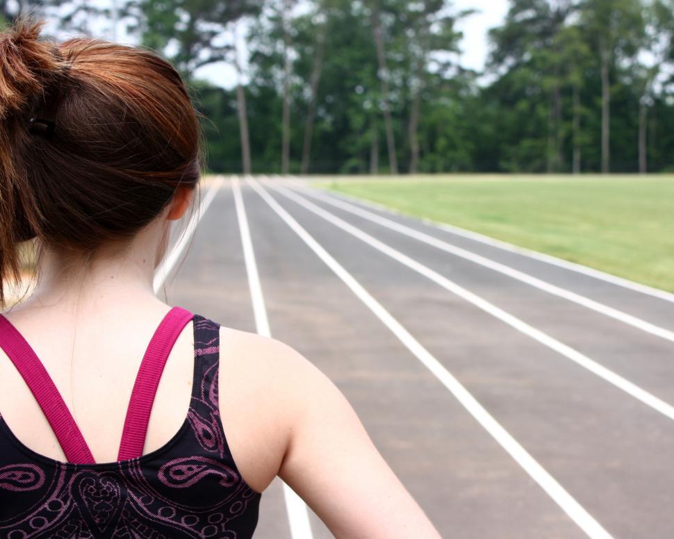 Free Image of A cute young girl on a track field 