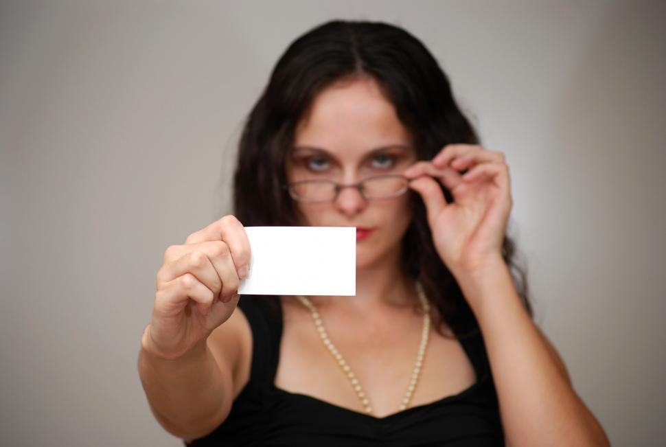 Free Image of A beautiful business woman holding a blank business card 