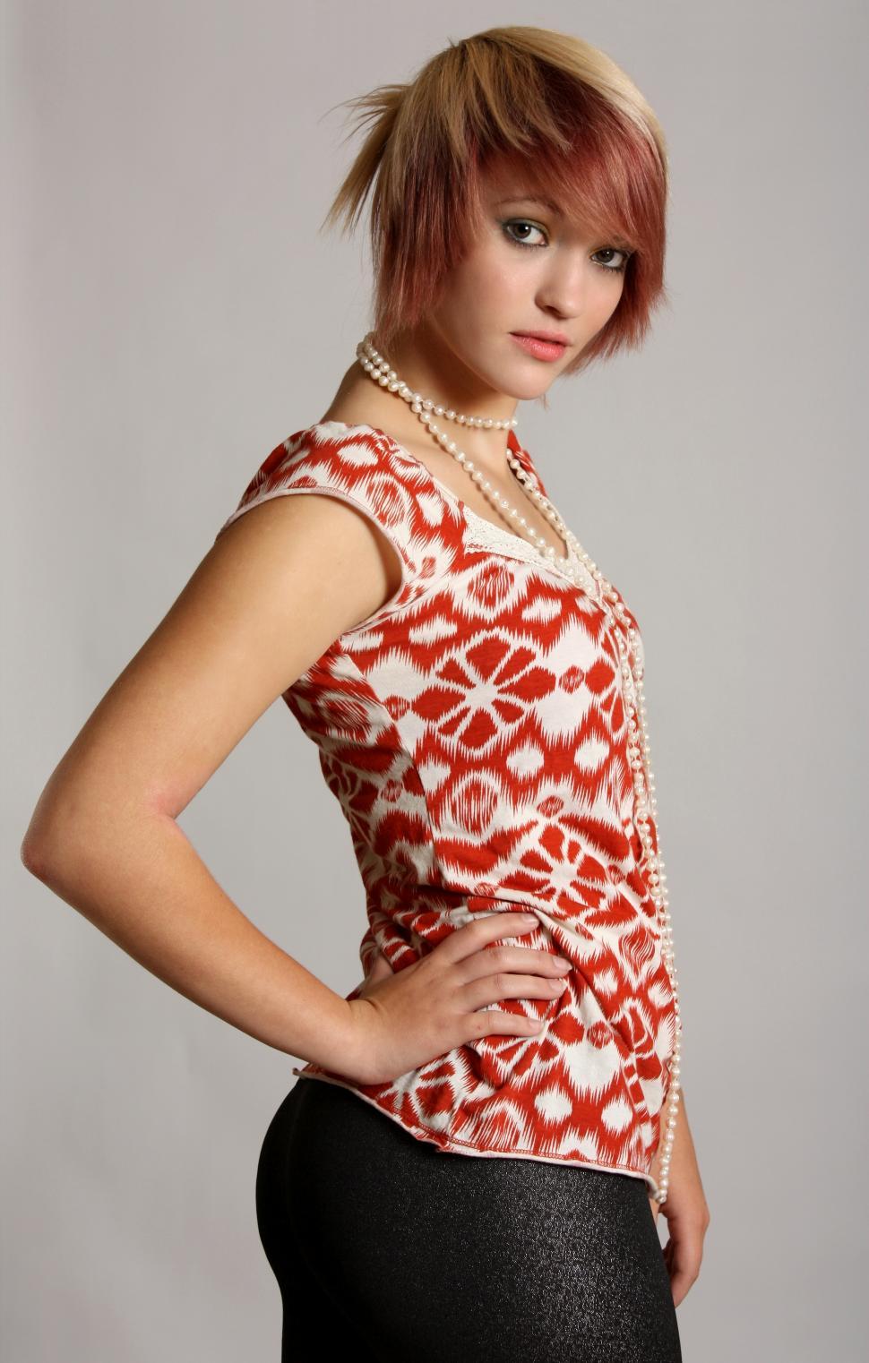 Free Stock Photo of A beautiful young woman wearing pearls posing on a