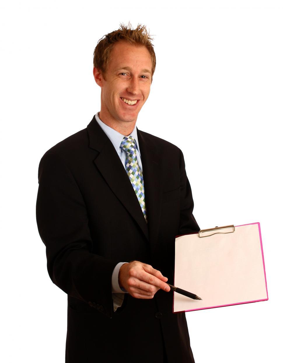 Free Image of A young businessman holding a clipboard and pen 