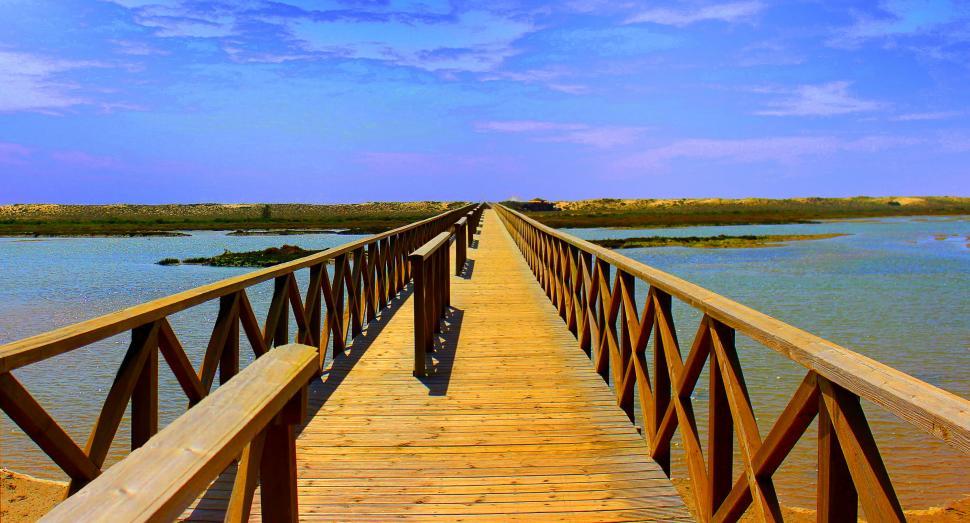 Free Stock Photo of Long wooden bridge crossing Ria Formosa at Quinta