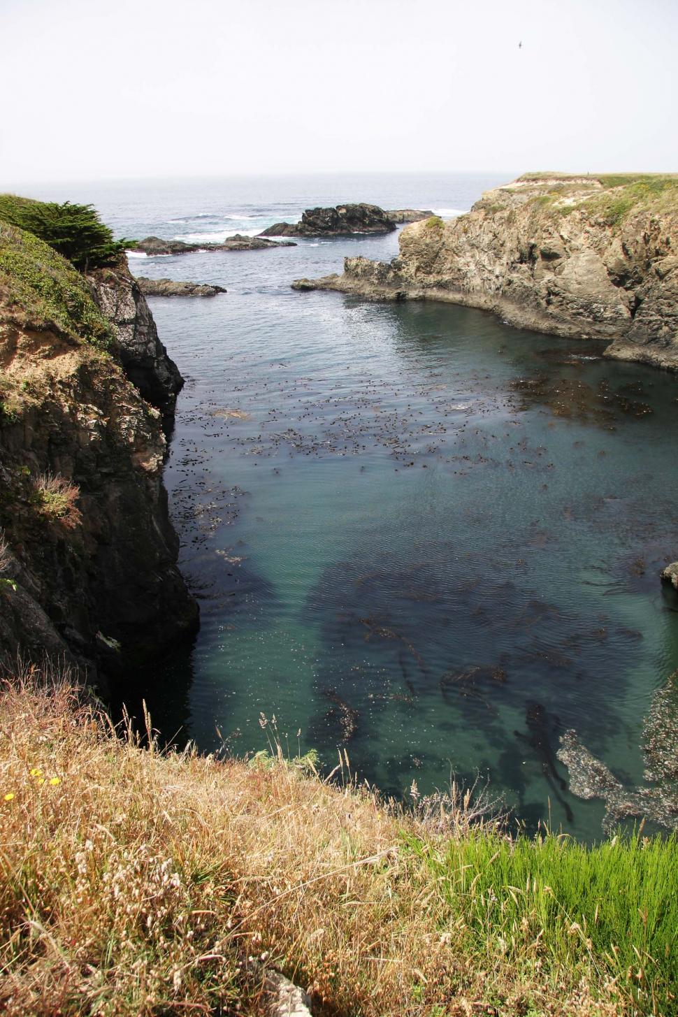 Free Stock Photo of Rocky Cliff Surrounding Body of Water | Download ...