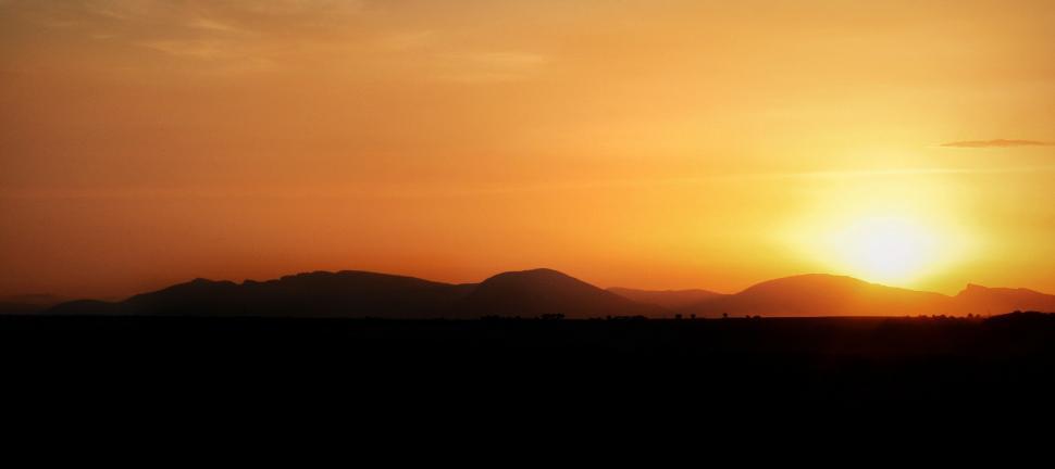 Free Image of Sun Setting Over Mountain Range 