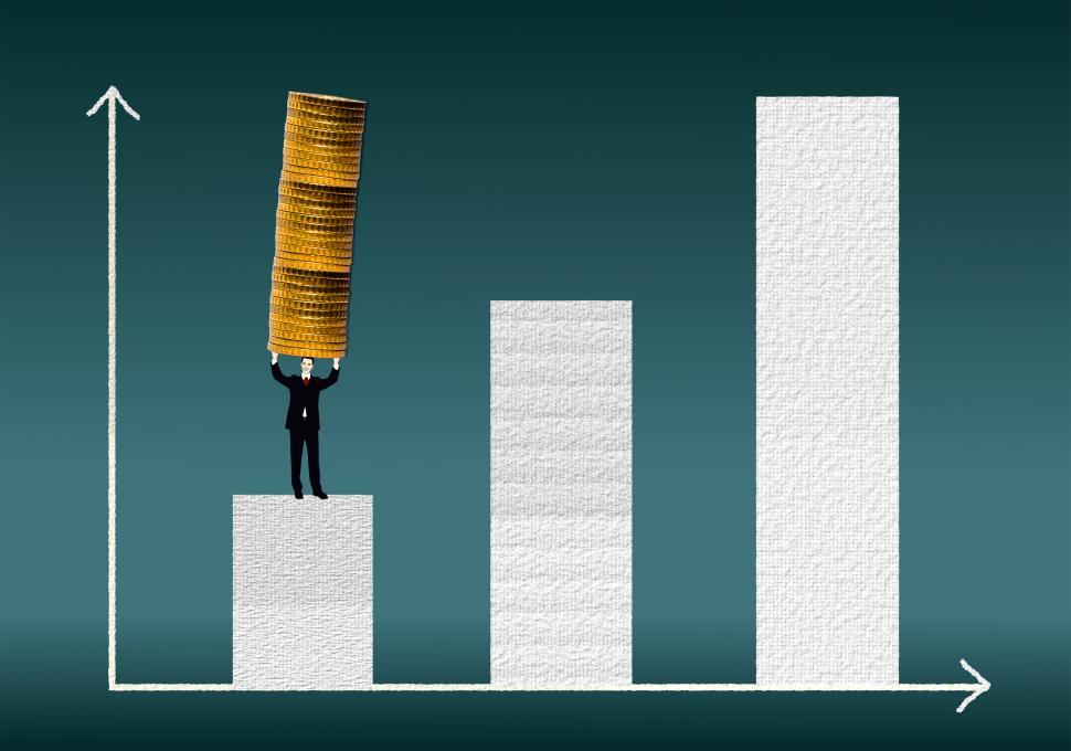 Businessman carrying a coin stack on a financial graph