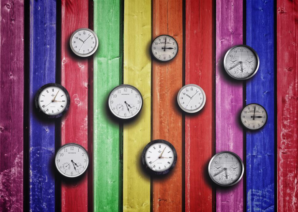 Free Stock Photo of Clocks on colorful wood background Time concept