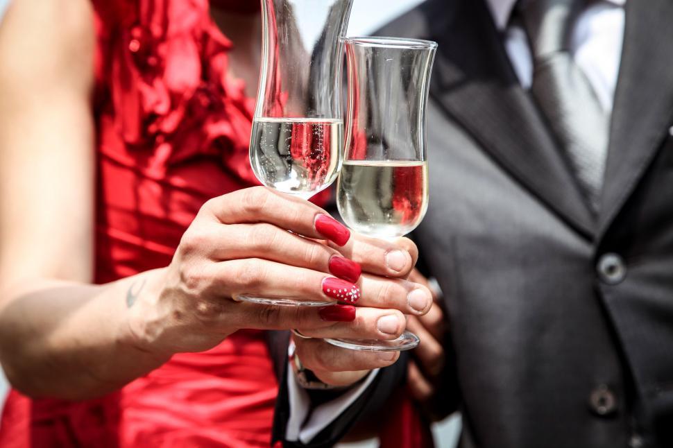 Free Image of Bride and groom holding champagne glasses 