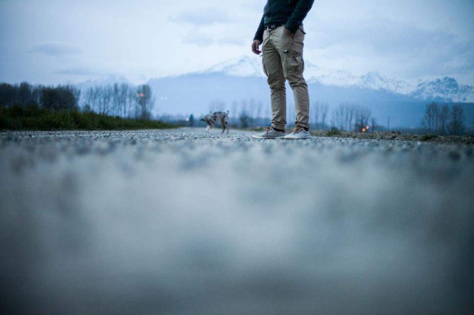 Free Image of Man Holding Umbrella Standing on Road 