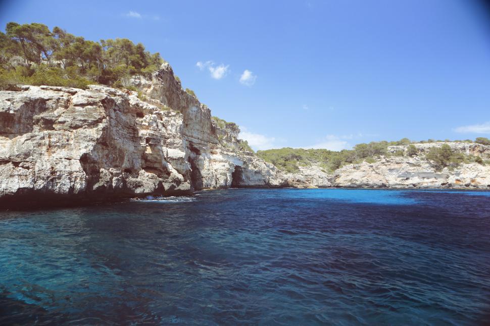 Free Image of Body of Water Near Rocky Cliff 