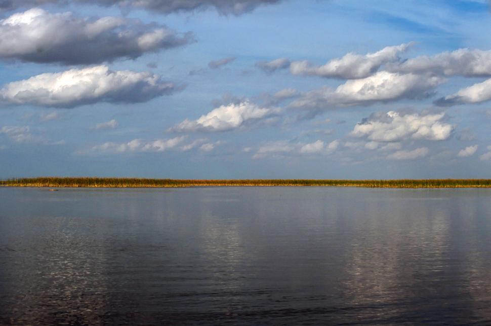 Free Image of White Clouds over river 