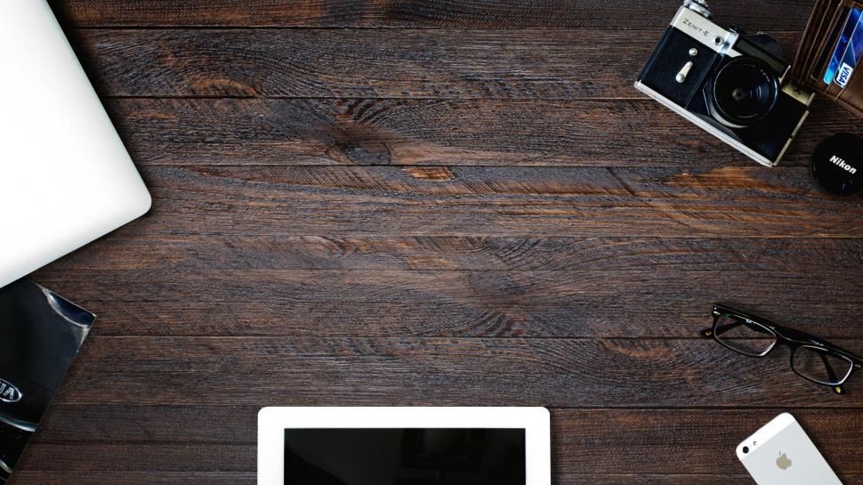 Free Image of Desk With Laptop, Camera, and Various Items 