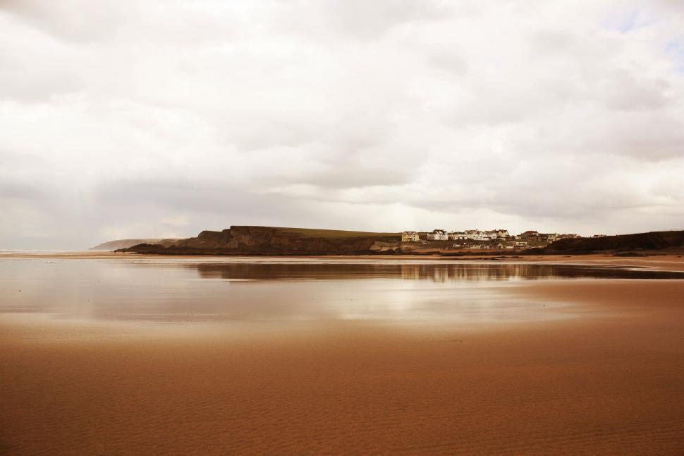 Free Image of Cloudy Sky Over Large Body of Water 
