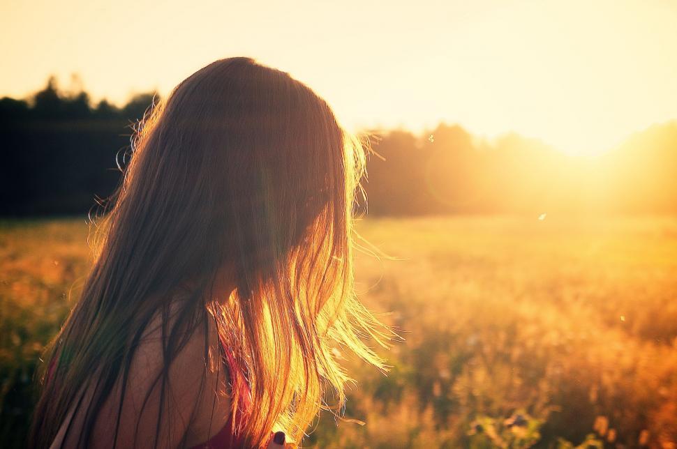 Free Image of Woman Standing in Field at Sunset 