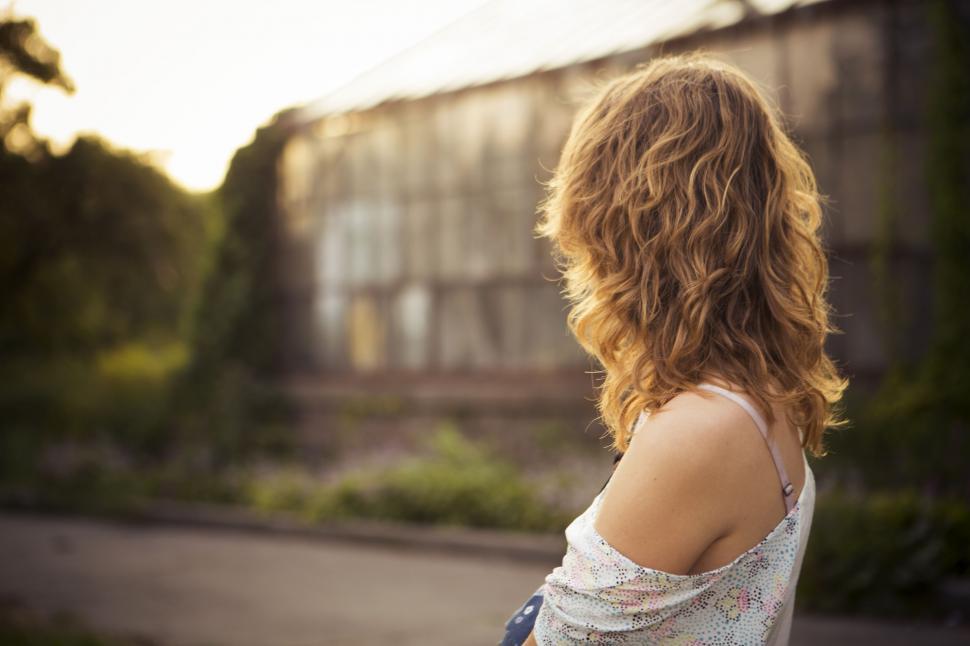 Free Image of Woman Standing in Front of Building 