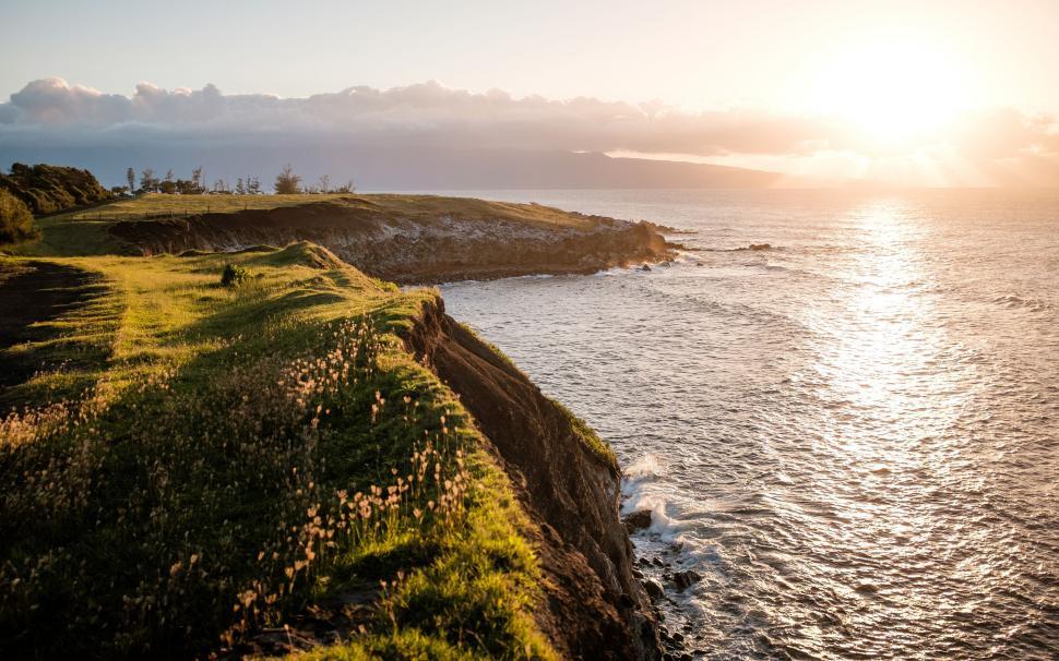 Free Image of Sun Setting Over Water Near Shore 