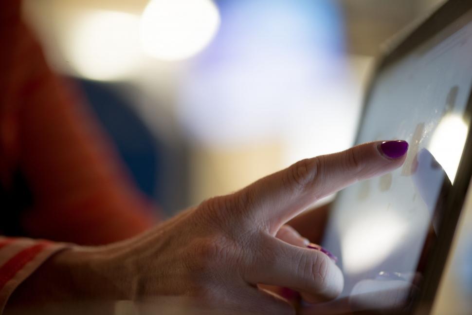 Free Image of Woman Using Laptop Computer With Finger on Screen 
